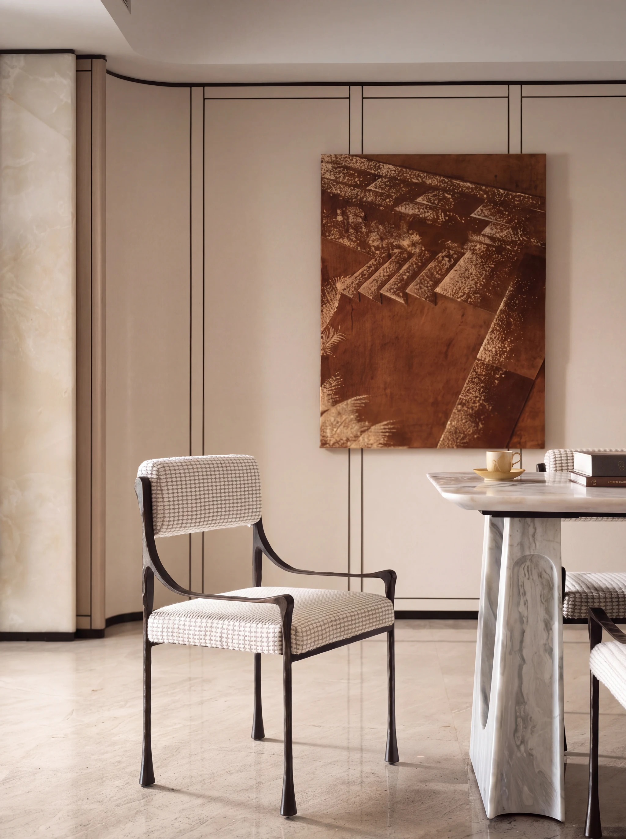 Forged bronze chair and a sculpted marble table