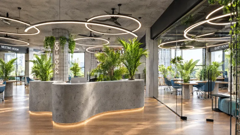 Reception: a sculpted concrete desk with planters and a warm LED underglow
